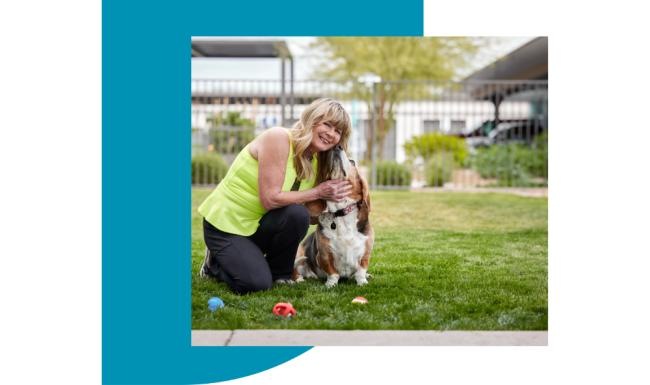 We're a pet-friendly community a person kneeling down holding a dog
